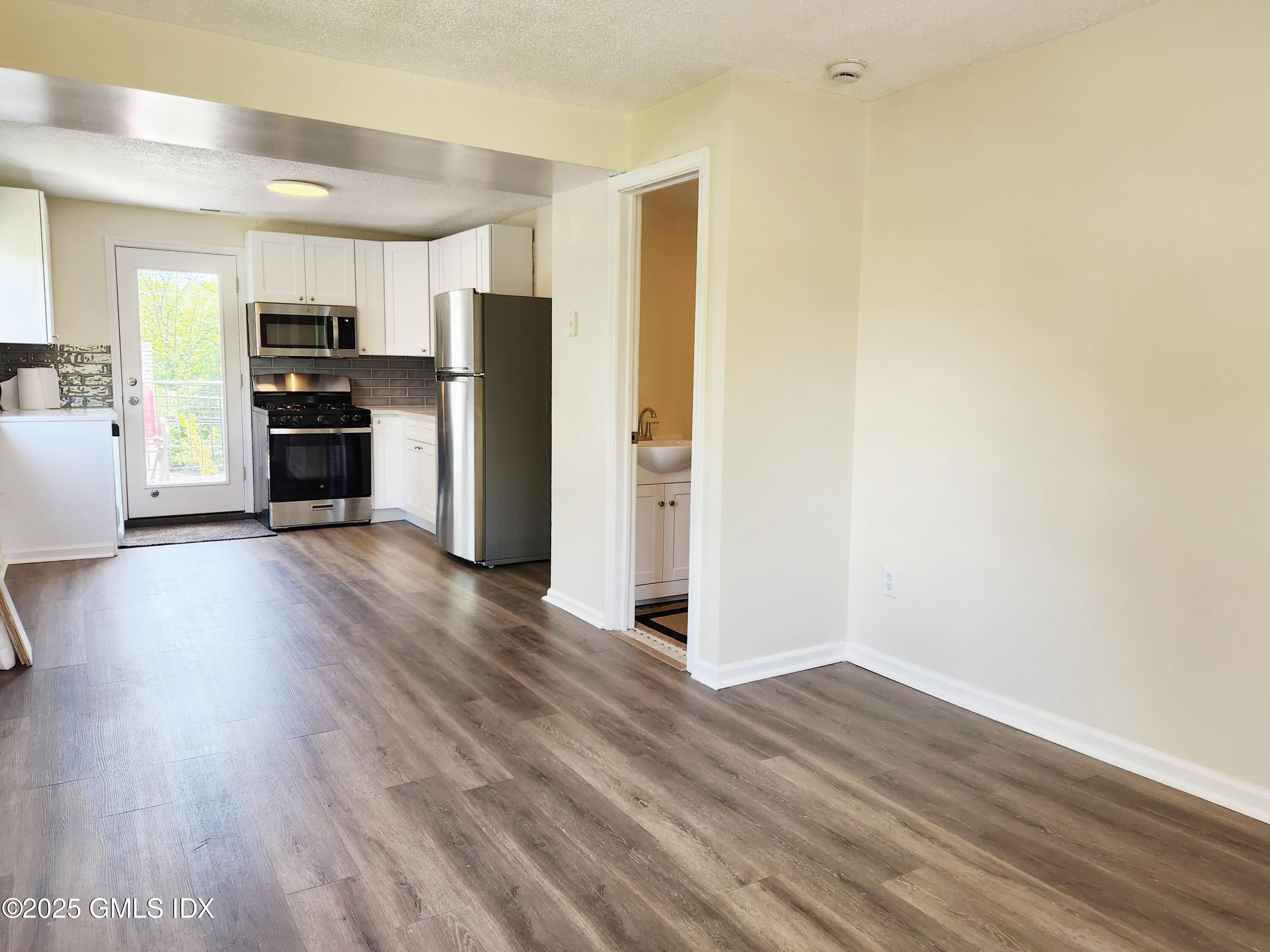 336 Hamilton Avenue, Unit B Greenwich, CT 06830 - Photo 5 of 16 a view of kitchen with wooden floor electronic appliances and window