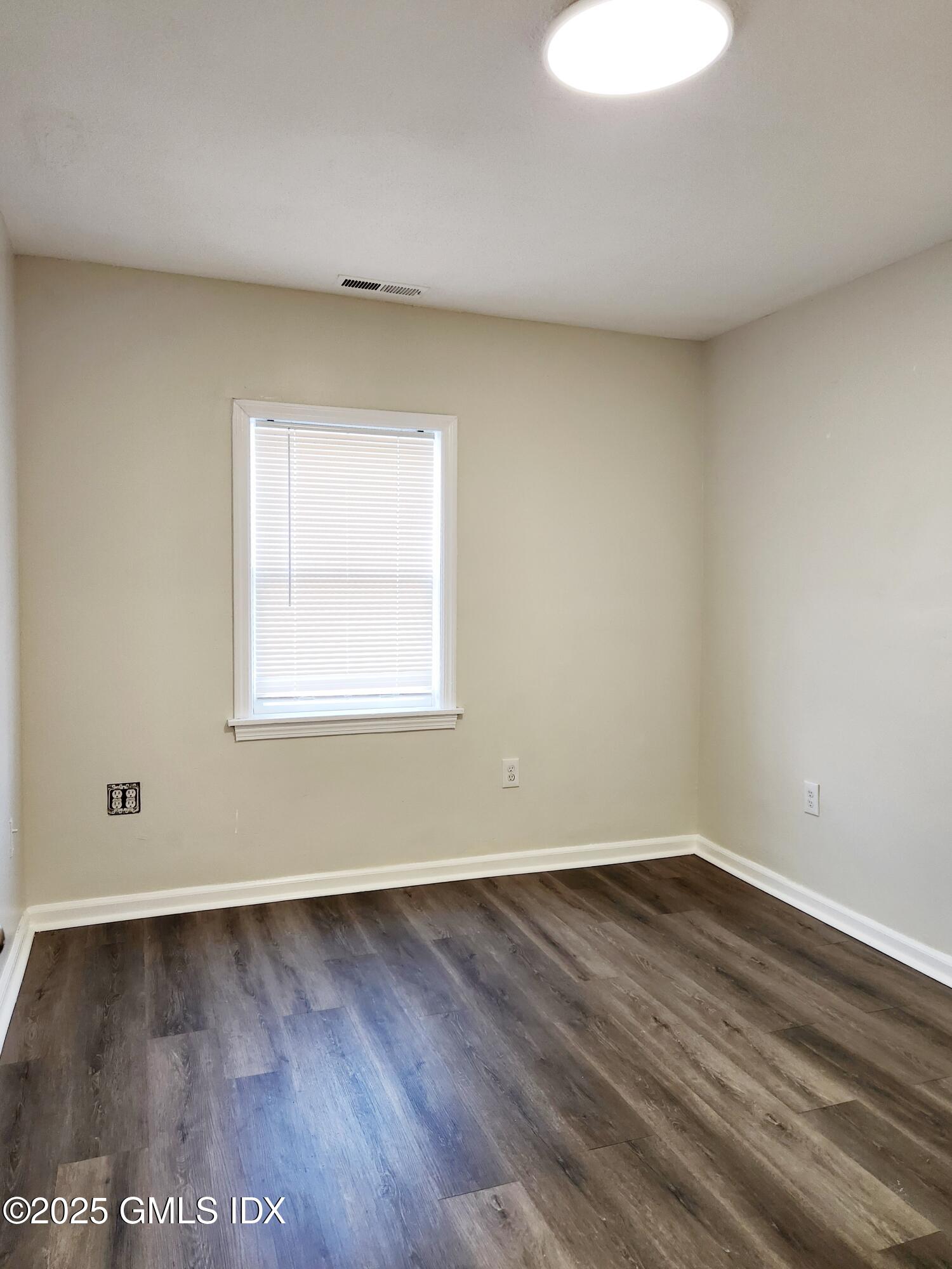 336 Hamilton Avenue, Unit B Greenwich, CT 06830 - Photo 9 of 16 wooden floor in an empty room with a window