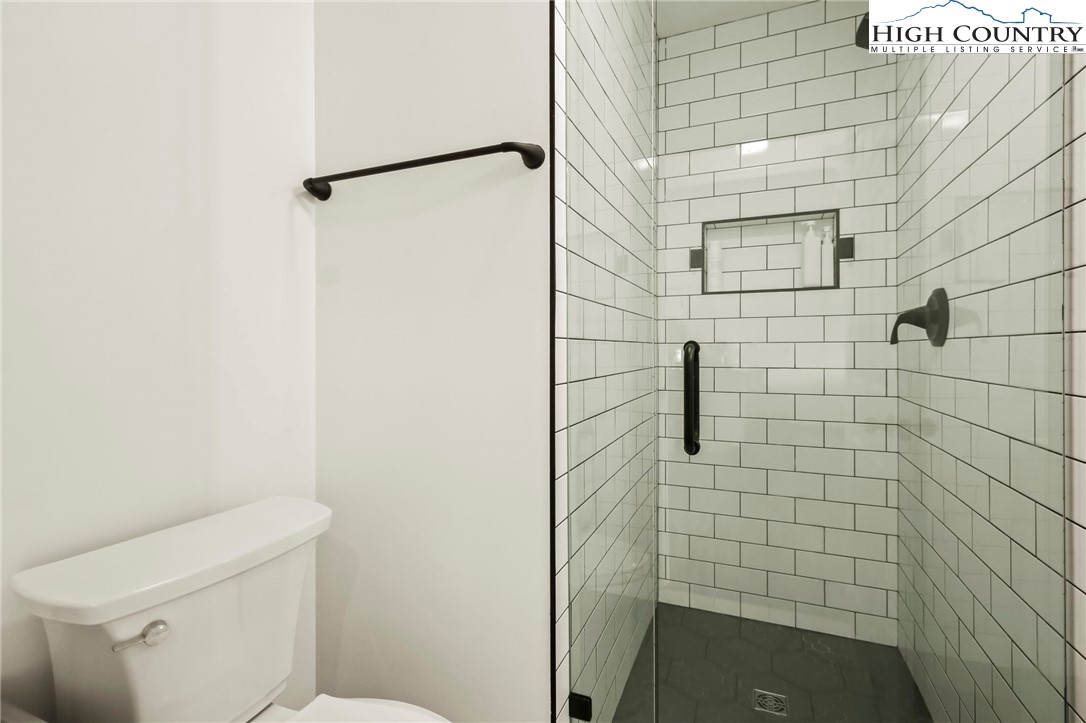 282 Charles Street Boone, NC 28607 - Photo 14 of 47 a bathroom with a shower and toilet