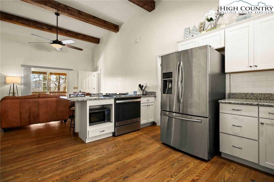 282 Charles Street Boone, NC 28607 - Photo 2 of 47 a kitchen with granite countertop a refrigerator and a stove top oven