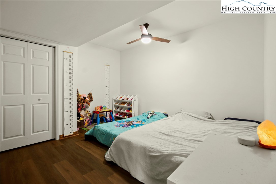 282 Charles Street Boone, NC 28607 - Photo 35 of 47 a bedroom with a bed and a chandelier