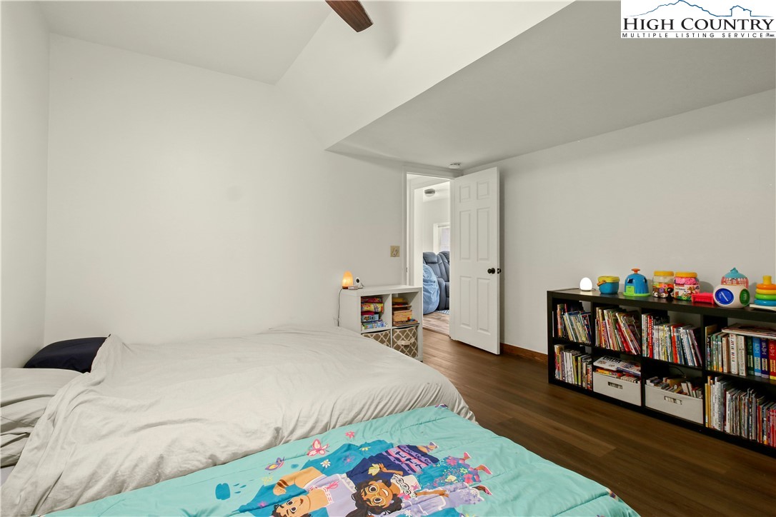 282 Charles Street Boone, NC 28607 - Photo 36 of 47 a bedroom with a bed and a book shelf