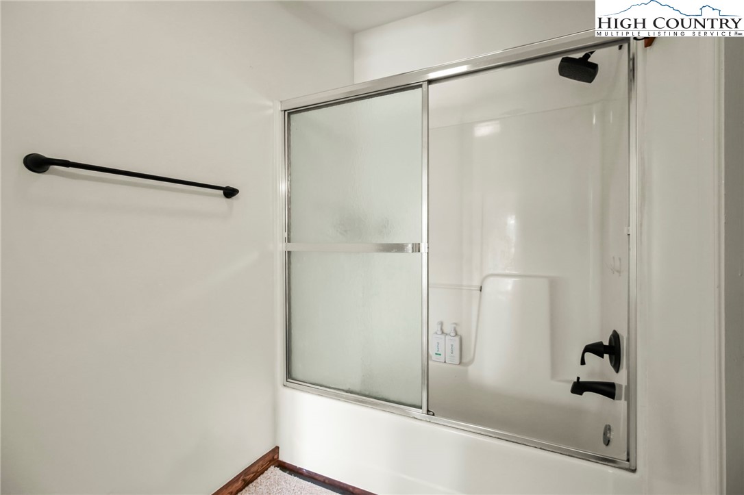 282 Charles Street Boone, NC 28607 - Photo 37 of 47 a bathroom with a glass shower door