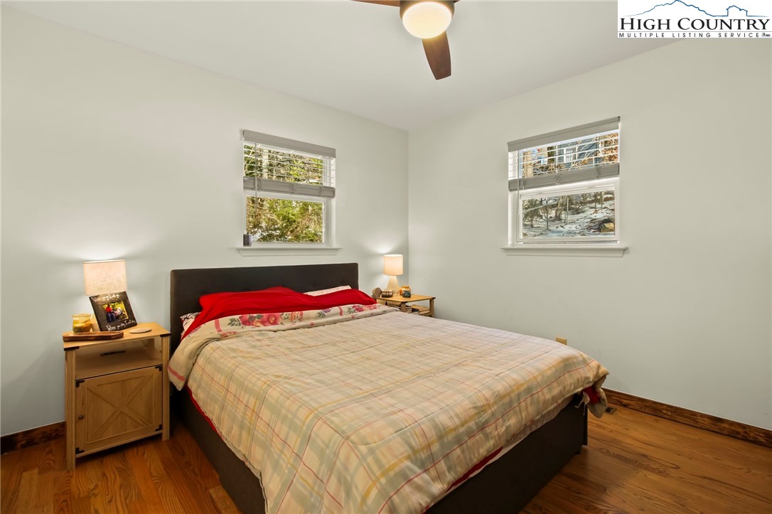 282 Charles Street Boone, NC 28607 - Photo 5 of 47 a bedroom with a bed and a lamp on table