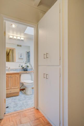 a bathroom with a sink a toilet and mirror