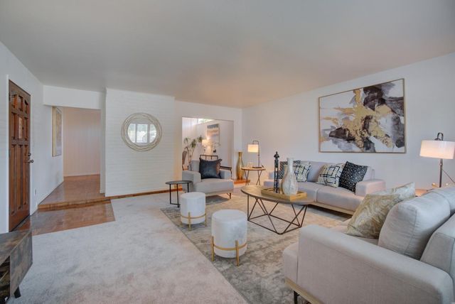 a living room with furniture and a mirror