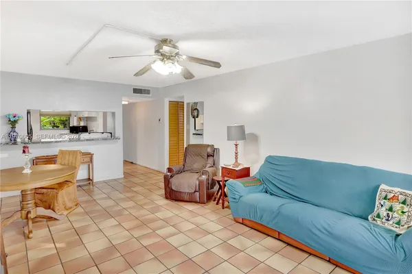 a living room with furniture and kitchen view