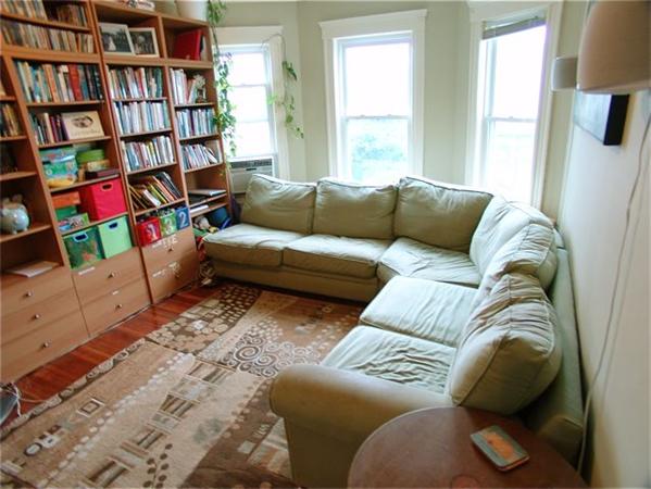 31 Torrey Street Boston, MA 02124 - Photo 2 of 11 a living room with furniture and a book shelf