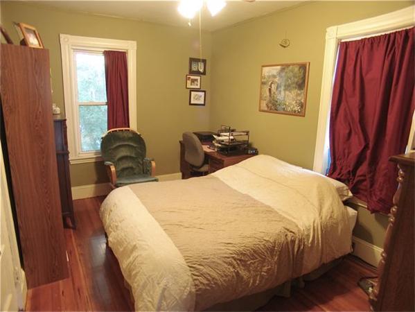 31 Torrey Street Boston, MA 02124 - Photo 4 of 11 a bed sitting in a bedroom next to a window