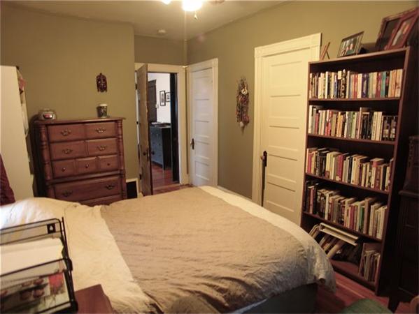 31 Torrey Street Boston, MA 02124 - Photo 5 of 11 a bedroom with a bed and a book shelf