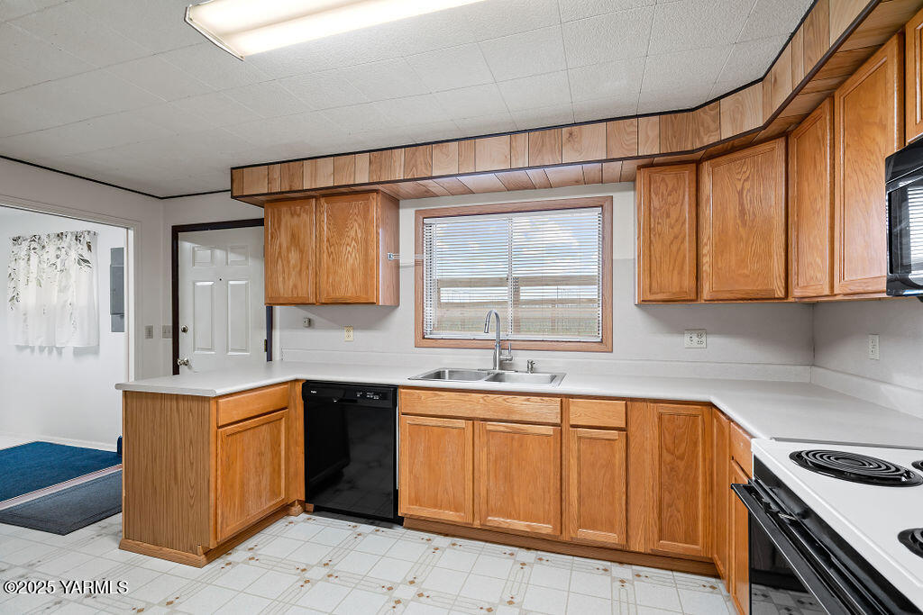 3820 Lateral B Road Wapato, WA 98951 - Photo 14 of 35 a kitchen with stainless steel appliances granite countertop a sink stove and cabinets