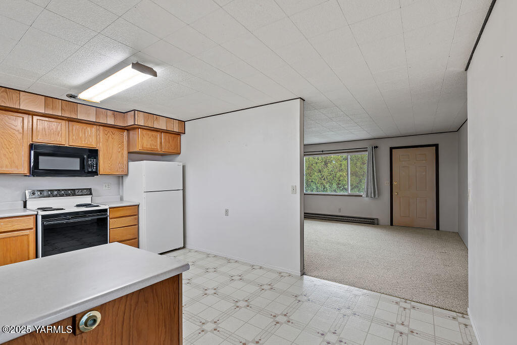 3820 Lateral B Road Wapato, WA 98951 - Photo 16 of 35 a kitchen with stainless steel appliances granite countertop a refrigerator and a stove top oven