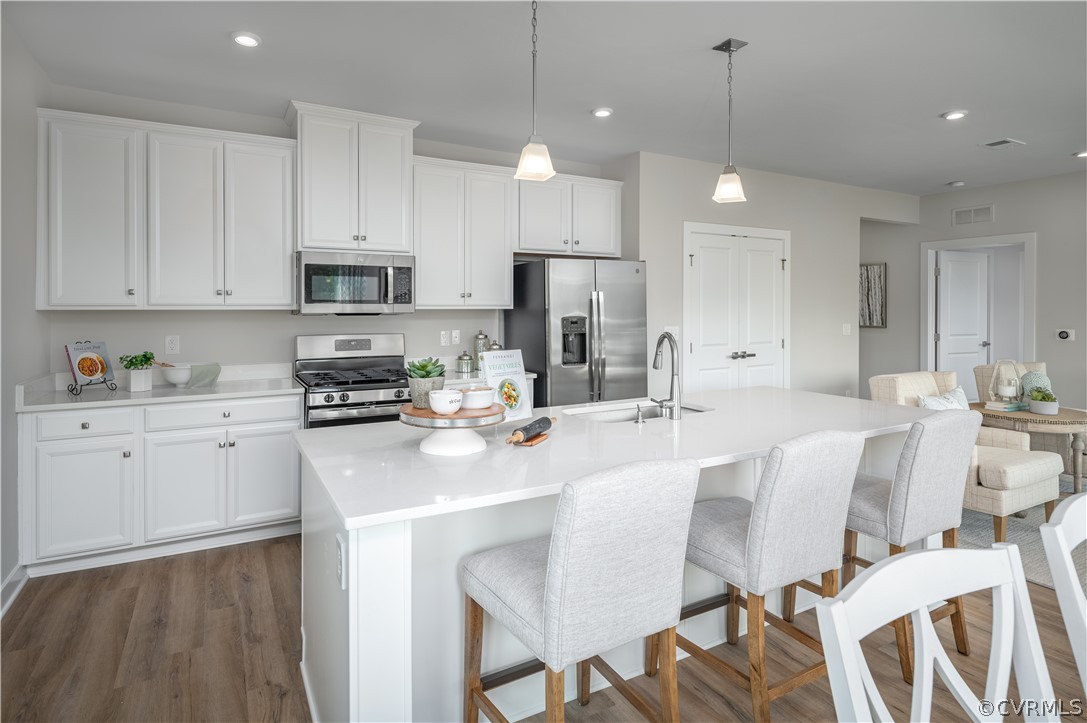 6601 Citory Way, Unit 305 Moseley, VA 23120 - Photo 3 of 23 a kitchen with stainless steel appliances kitchen island granite countertop a sink and cabinets