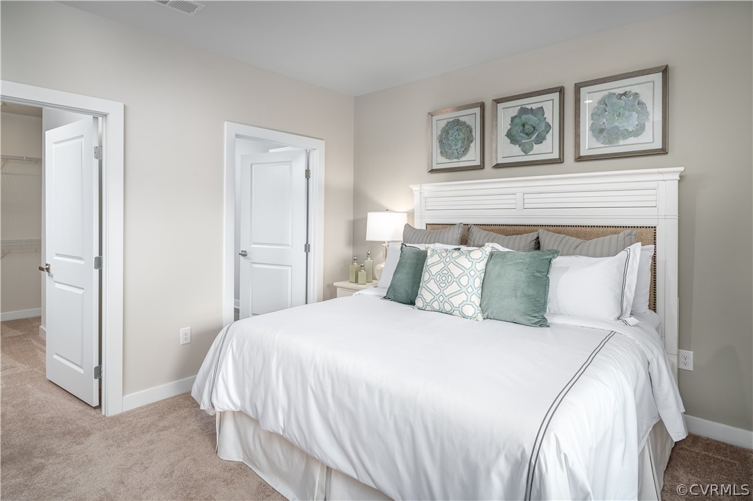 6601 Citory Way, Unit 305 Moseley, VA 23120 - Photo 8 of 23 a large white bed in a white room