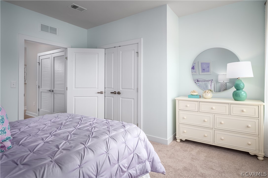 6601 Citory Way, Unit 305 Moseley, VA 23120 - Photo 9 of 23 a bedroom with a bed a dresser and a mirror