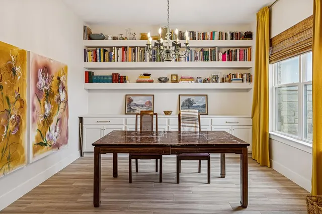 a dining room with furniture and wooden floor