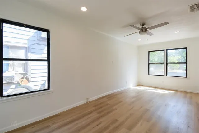wooden floor in an empty room with a window