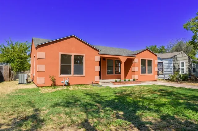 a front view of a house with a yard and porch