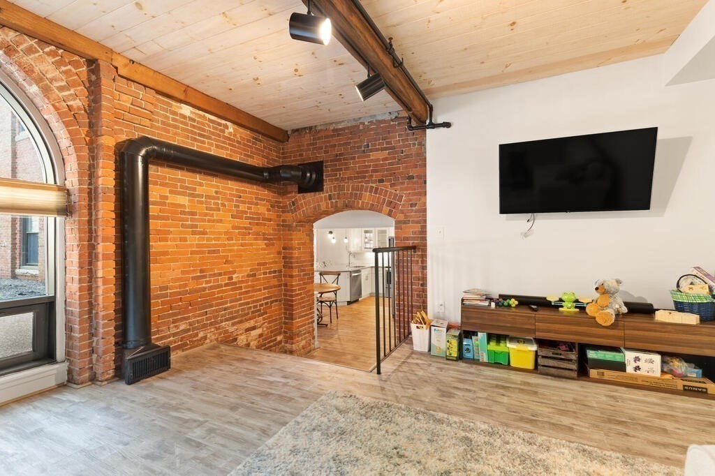 50 Rantoul Street, Unit 110 Beverly, MA 01915 - Photo 12 of 37 a view of a livingroom with furniture and flat screen tv