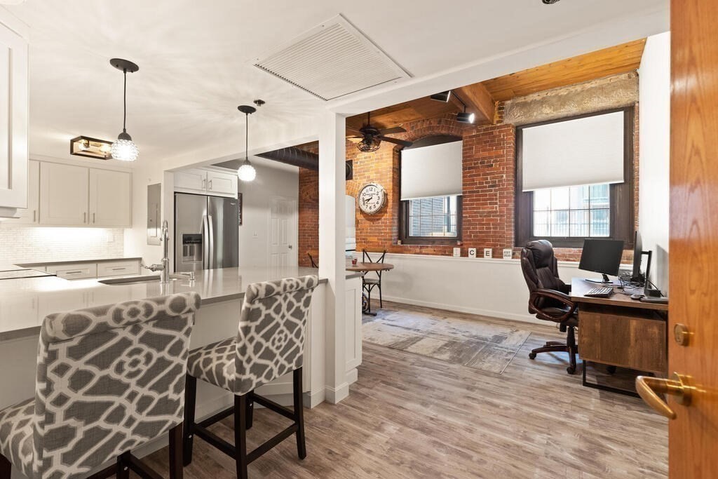 50 Rantoul Street, Unit 110 Beverly, MA 01915 - Photo 14 of 37 a view of a dining room and livingroom with furniture wooden floor a chandelier