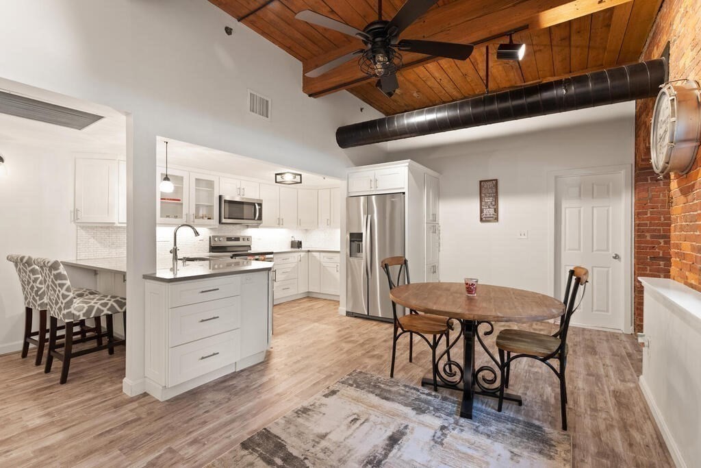 50 Rantoul Street, Unit 110 Beverly, MA 01915 - Photo 16 of 37 a view of a dining room with furniture and wooden floor