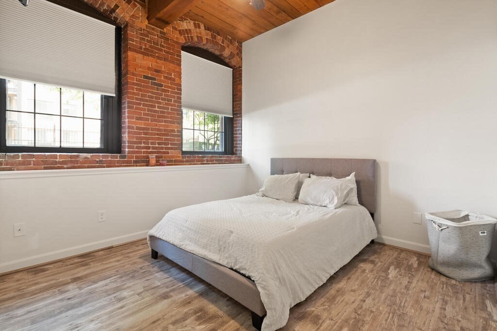 50 Rantoul Street, Unit 110 Beverly, MA 01915 - Photo 22 of 37 a large bed sitting in a bedroom next to a window