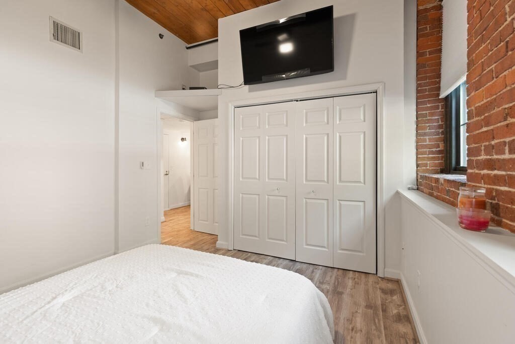 50 Rantoul Street, Unit 110 Beverly, MA 01915 - Photo 24 of 37 a bedroom with a bed and a flat screen tv