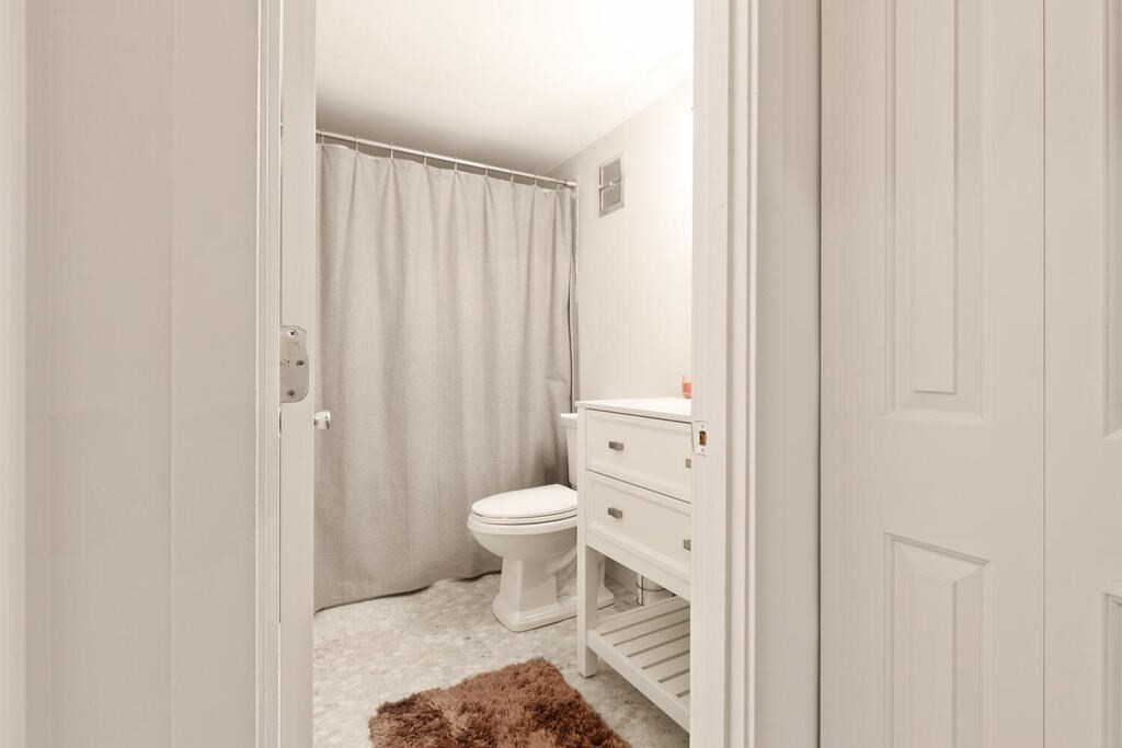 50 Rantoul Street, Unit 110 Beverly, MA 01915 - Photo 25 of 37 a bathroom with a toilet and a shower curtain