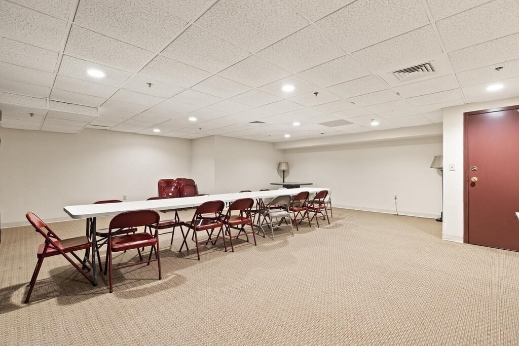 50 Rantoul Street, Unit 110 Beverly, MA 01915 - Photo 34 of 37 a big room with chairs