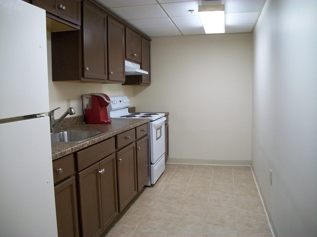 50 Rantoul Street, Unit 110 Beverly, MA 01915 - Photo 35 of 37 a kitchen with sink and cabinets