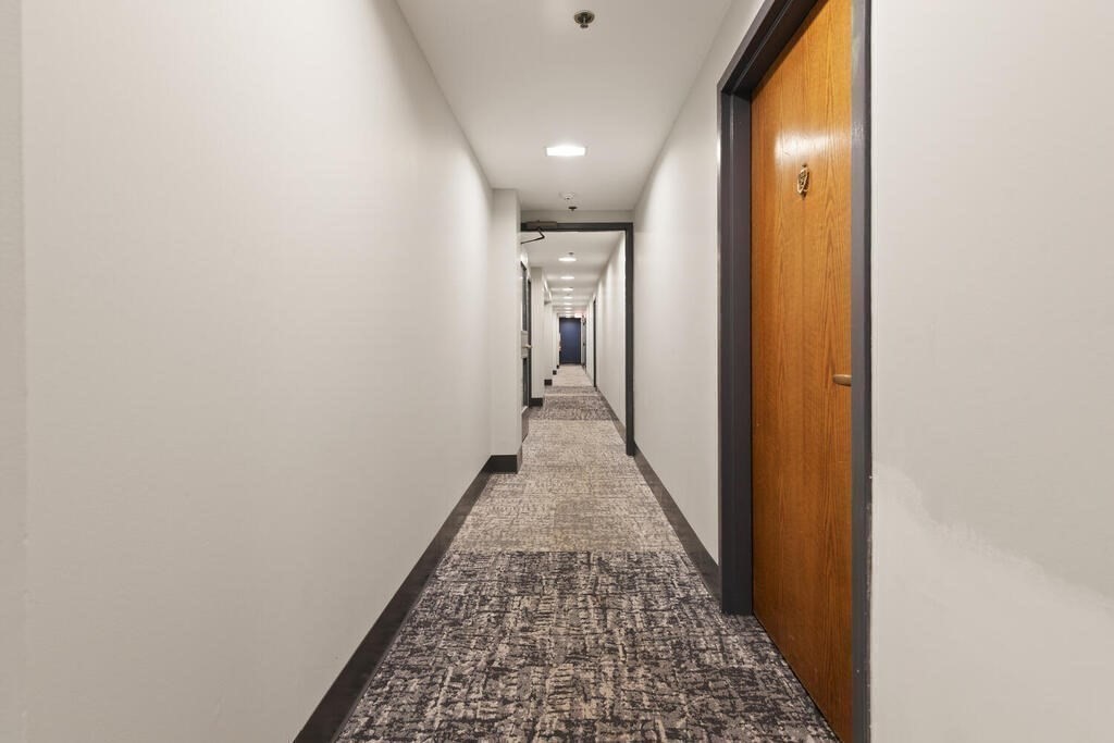50 Rantoul Street, Unit 110 Beverly, MA 01915 - Photo 9 of 37 a view of a hallway with wooden floor
