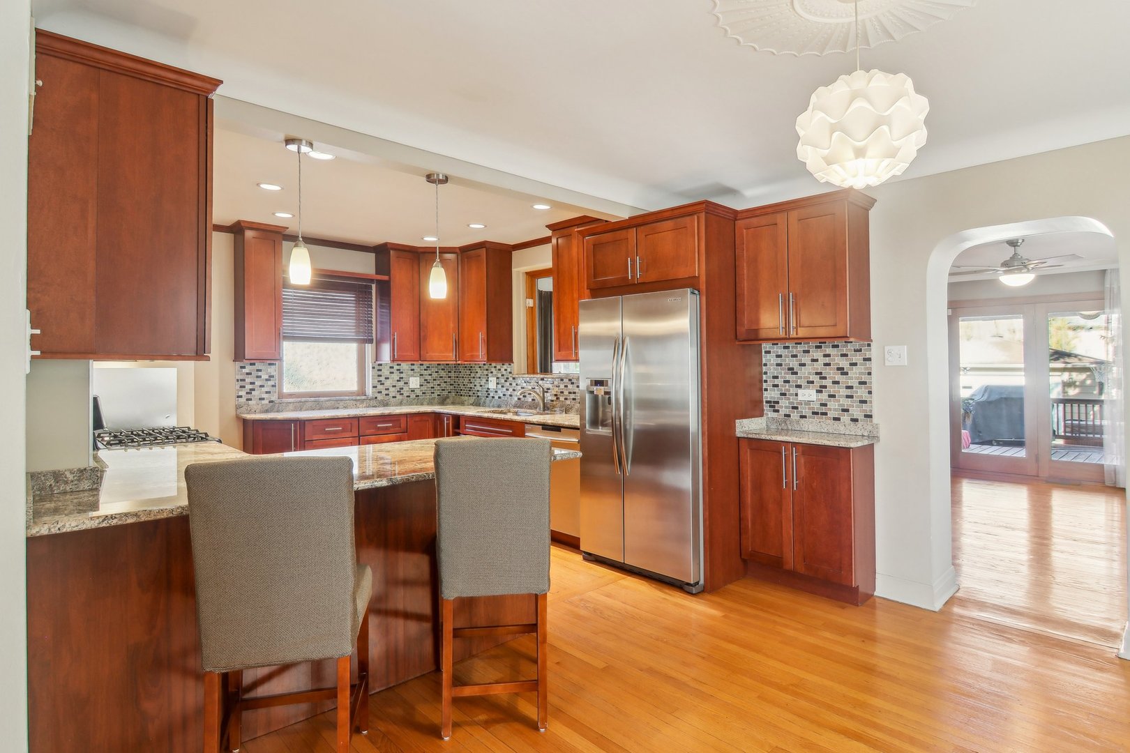 38 Northgate Road Riverside, IL 60546 - Photo 9 of 52 a kitchen with stainless steel appliances granite countertop a table chairs and a refrigerator