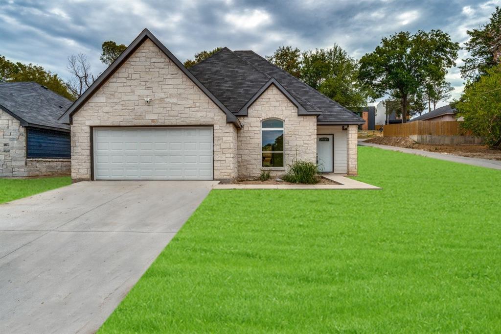 a front view of house with yard and green space