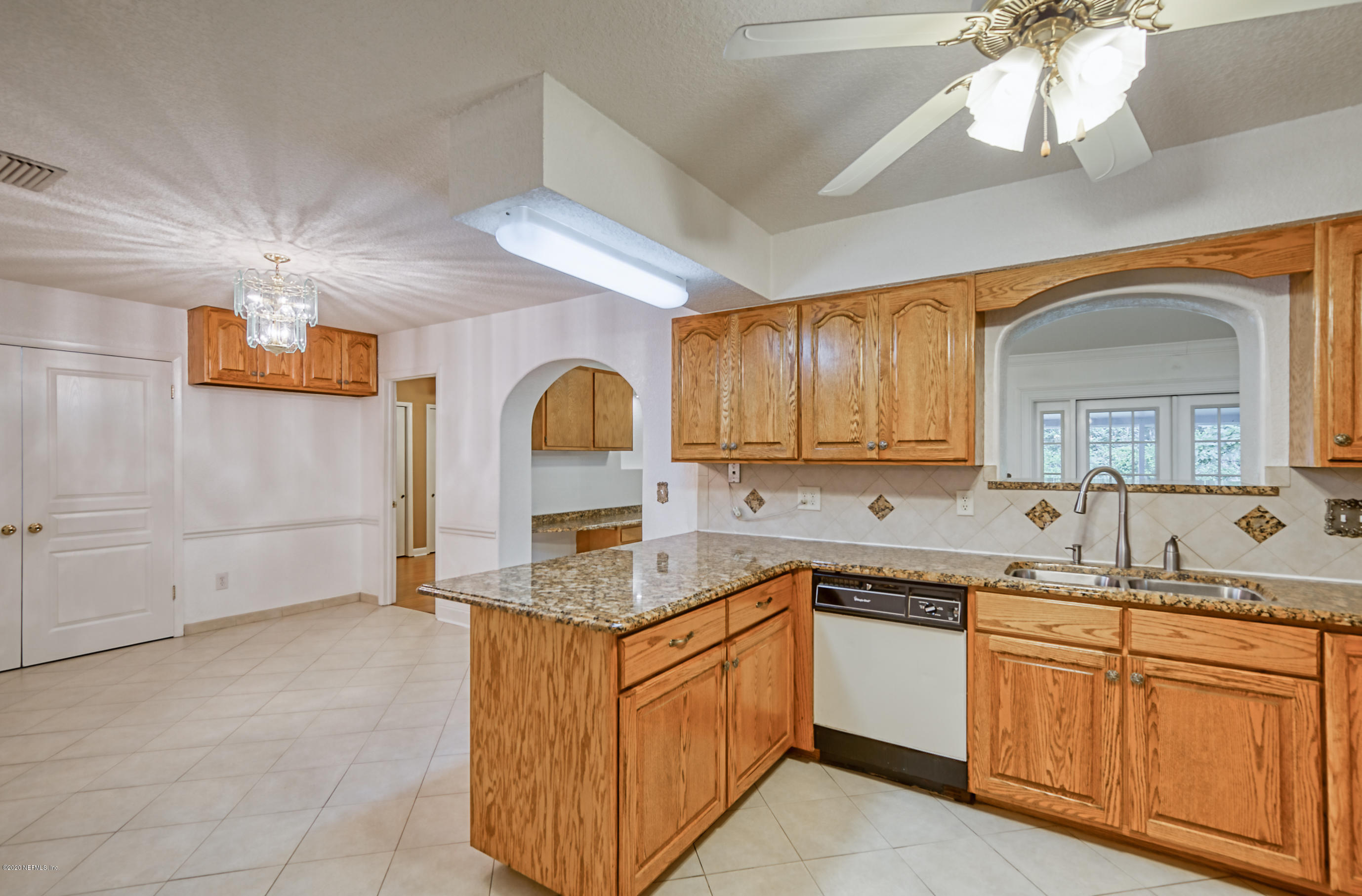 4024 Heath Road Jacksonville, FL 32277 - Photo 26 of 37 a kitchen with stainless steel appliances granite countertop a sink dishwasher stove and cabinets with wooden floor