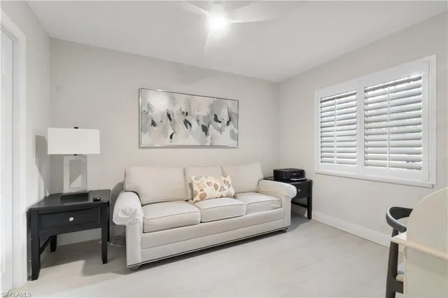 a living room with furniture and a window