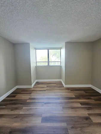 a view of wooden floor and windows in a room