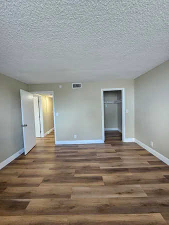 a view of wooden floor and cabinet in a room