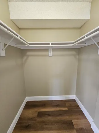 a view of a room with wooden floor