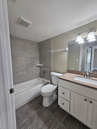 a bathroom with a double vanity sink toilet and shower