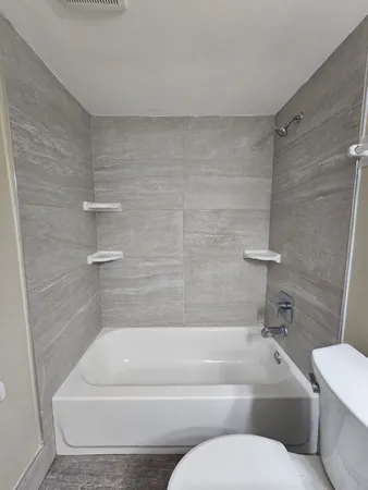 a bathroom with a toilet and bathtub