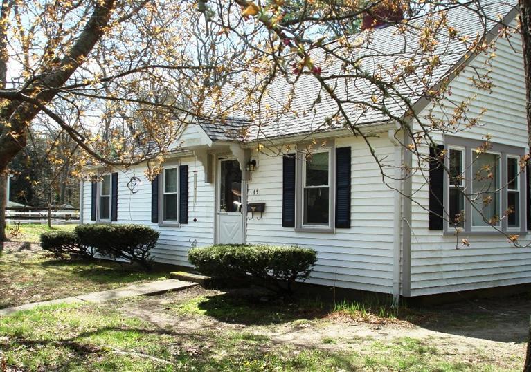 45 Johnny Cake Road Centerville, MA 02632 - Photo 1 of 5 a front view of a house with a yard covered outdoor space and fountain