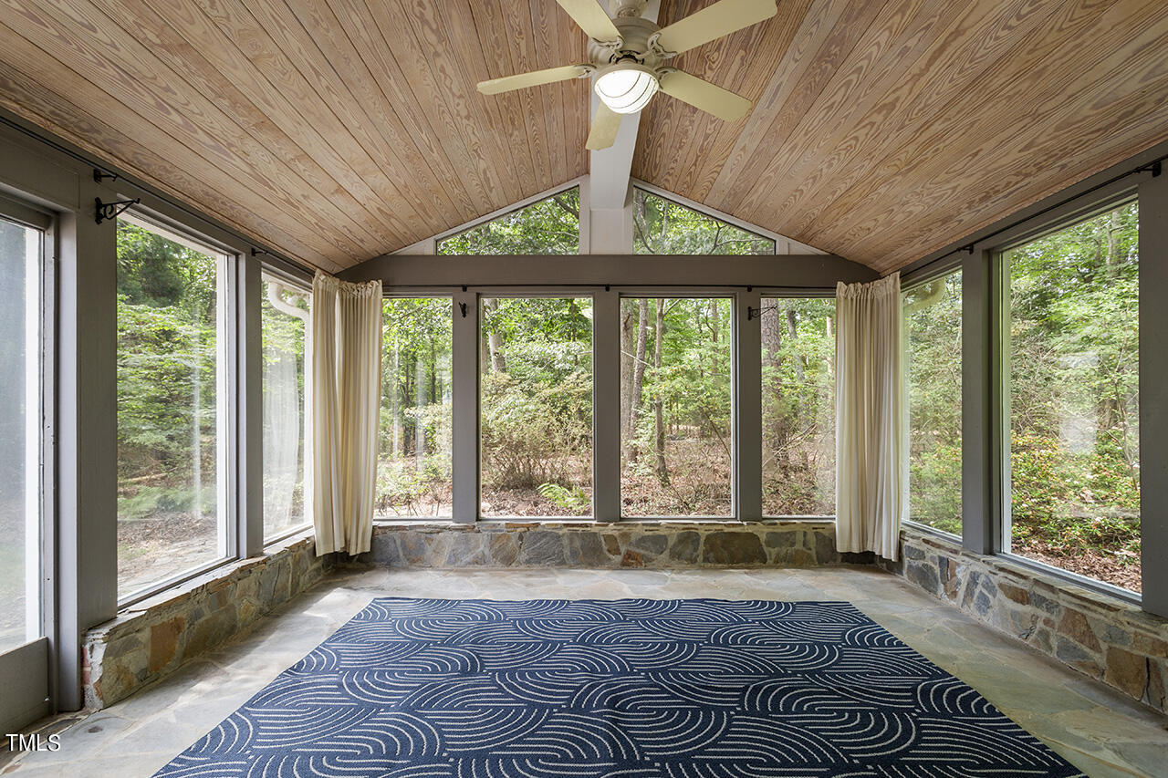 409 Amelia Avenue Raleigh, NC 27615 - Photo 8 of 46 a view of an empty room with wooden floor and a window