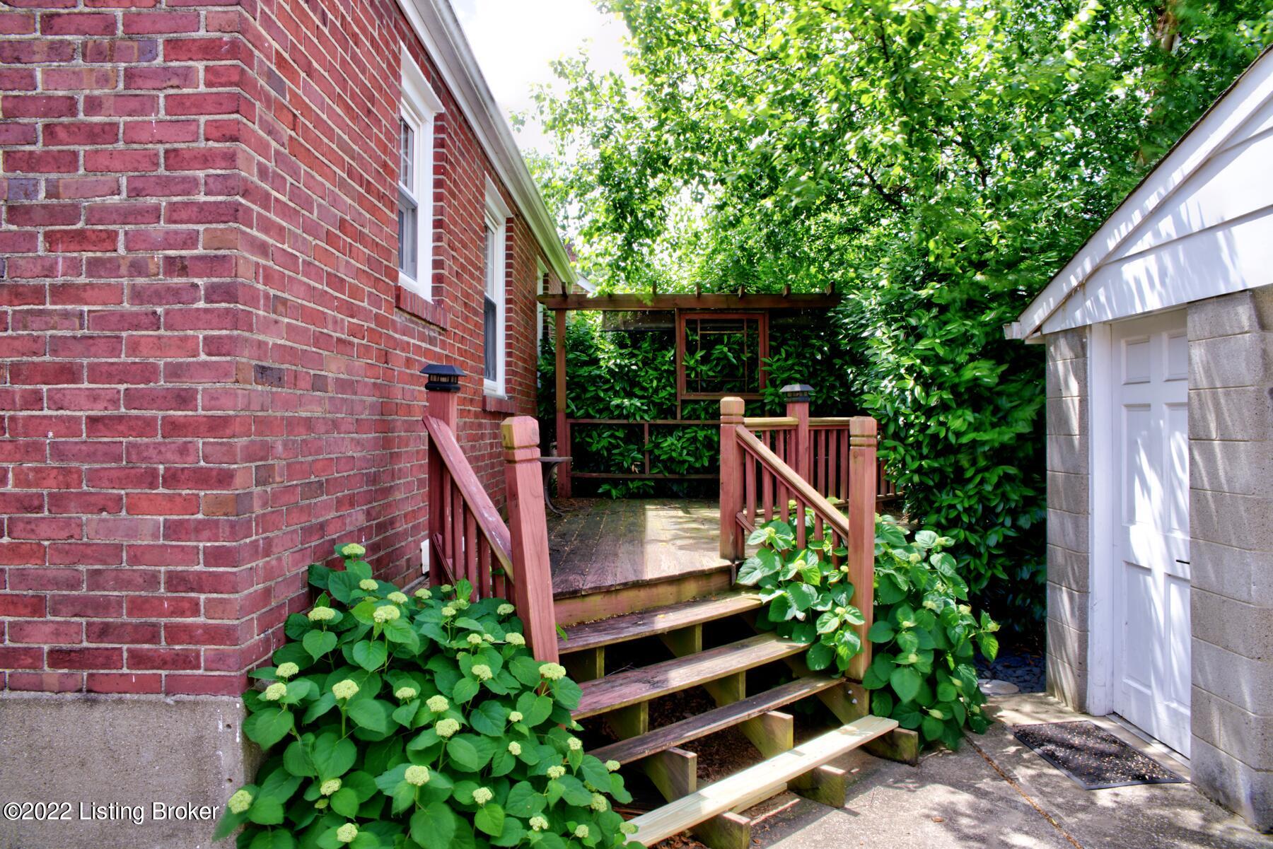 3006 Beaumont Road Louisville, KY 40205 - Photo 25 of 30 There is a nicely sized yard between the garage and the deck. The bush needs to be trimmed down for easier access