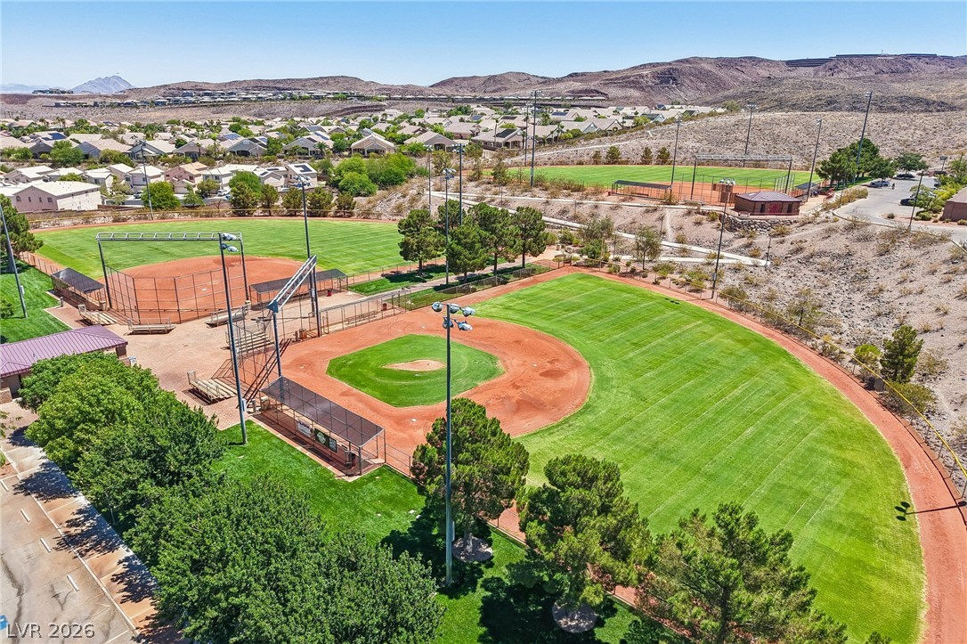 1176 Butternut Ranch Court Henderson, NV 89052 - Photo 58 of 60 Green fields and multiple ballparks for active community enjoyment, surrounded by residential areas and distant mountains.