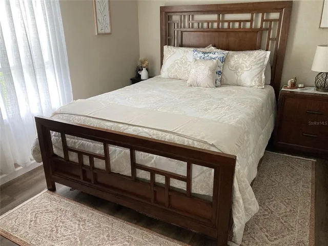 a bed sitting in a bedroom next to a window