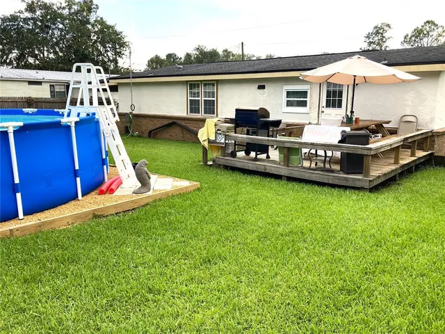 a view of a house with backyard patio and fire pit