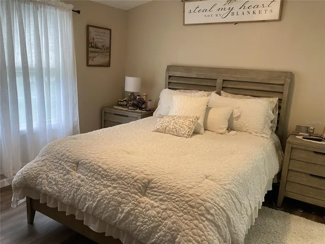 a large bed sitting in a bedroom next to a cabinet
