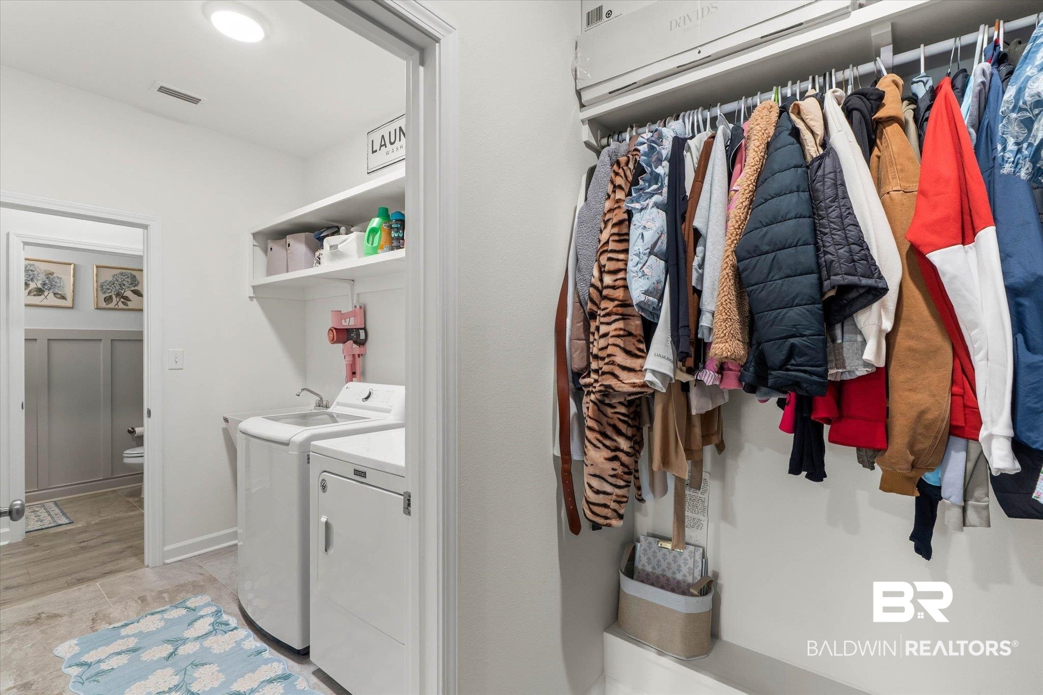 9074 Moses Way Theodore, AL 36582 - Photo 28 of 52 Dedicated laundry area featuring a utility sink, upper shelving, and tiled flooring