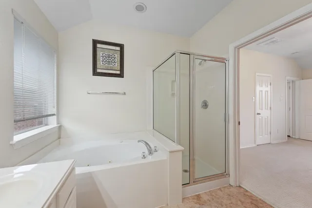 a bathroom with a bathtub and a shower