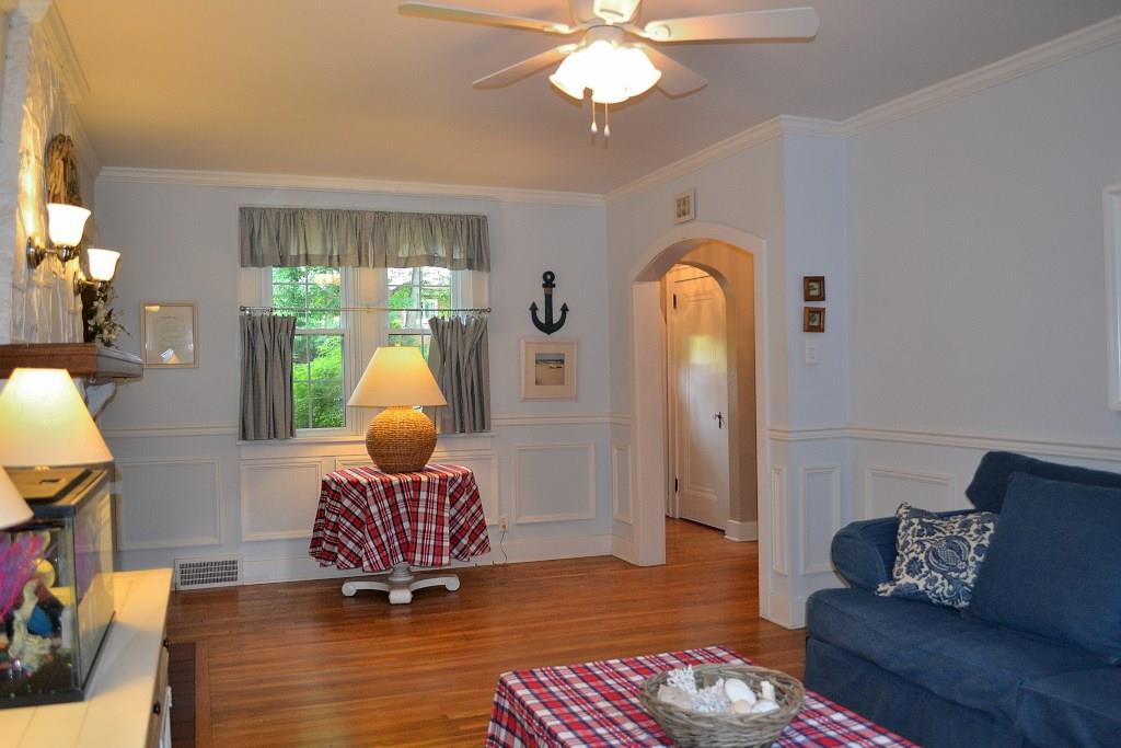 5600 Meridian Road Gibsonia, PA 15044 - Photo 11 of 25 Another view of the Living Room, with beautiful hardwood flooring, lovely wall scones at the fireplace and a ceiling fan. If you haven't noticed, yet--most all the sparkling windows in the home are newer, double-paned windows.